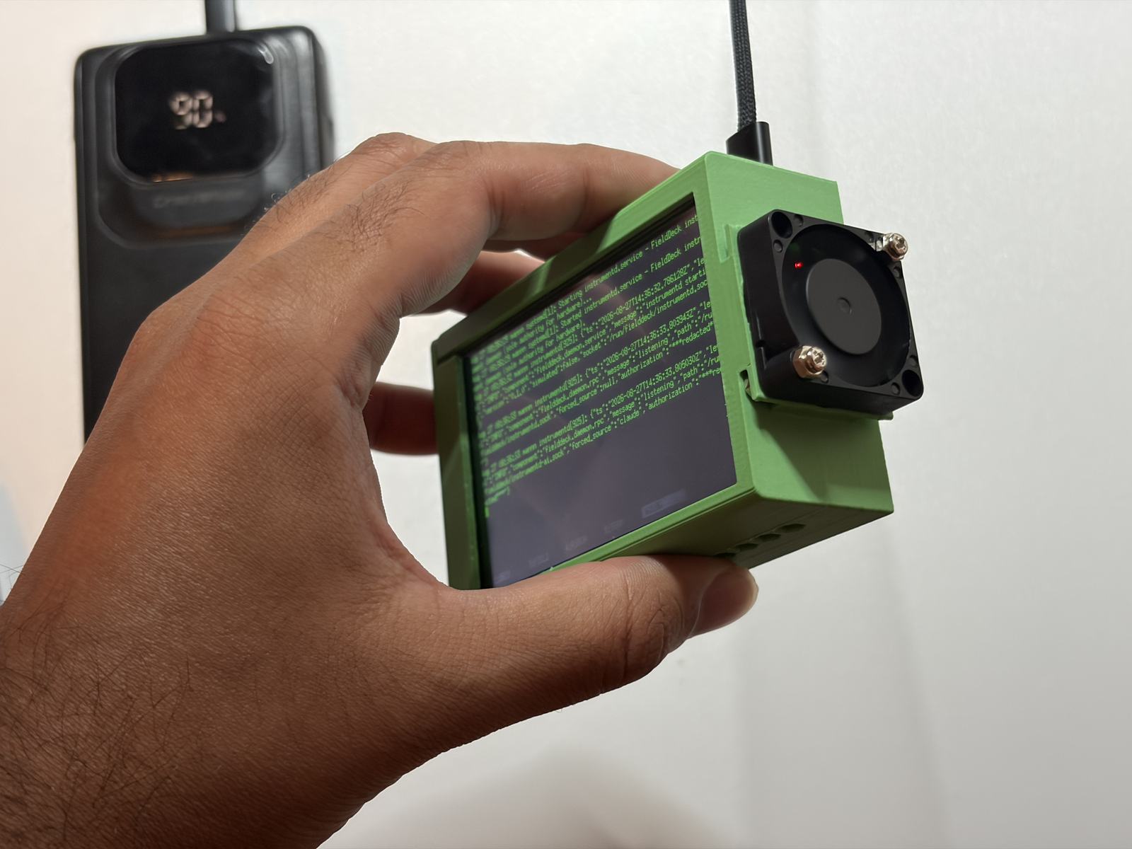 The whole thing in one hand: a Pi, a panel and a fan in a printed case.
