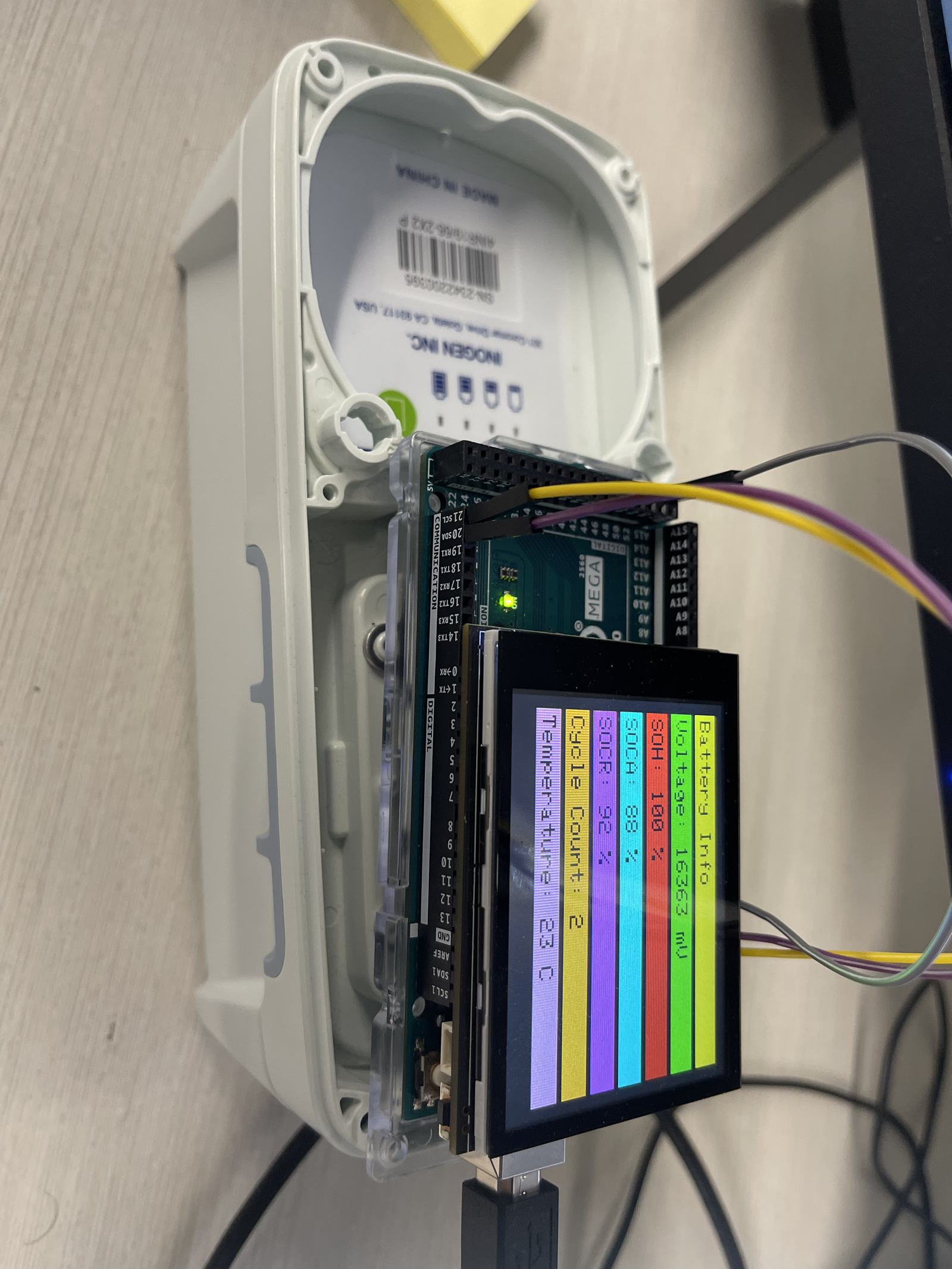 The TI BQ battery control prototype, open, with its board and screen wired in.