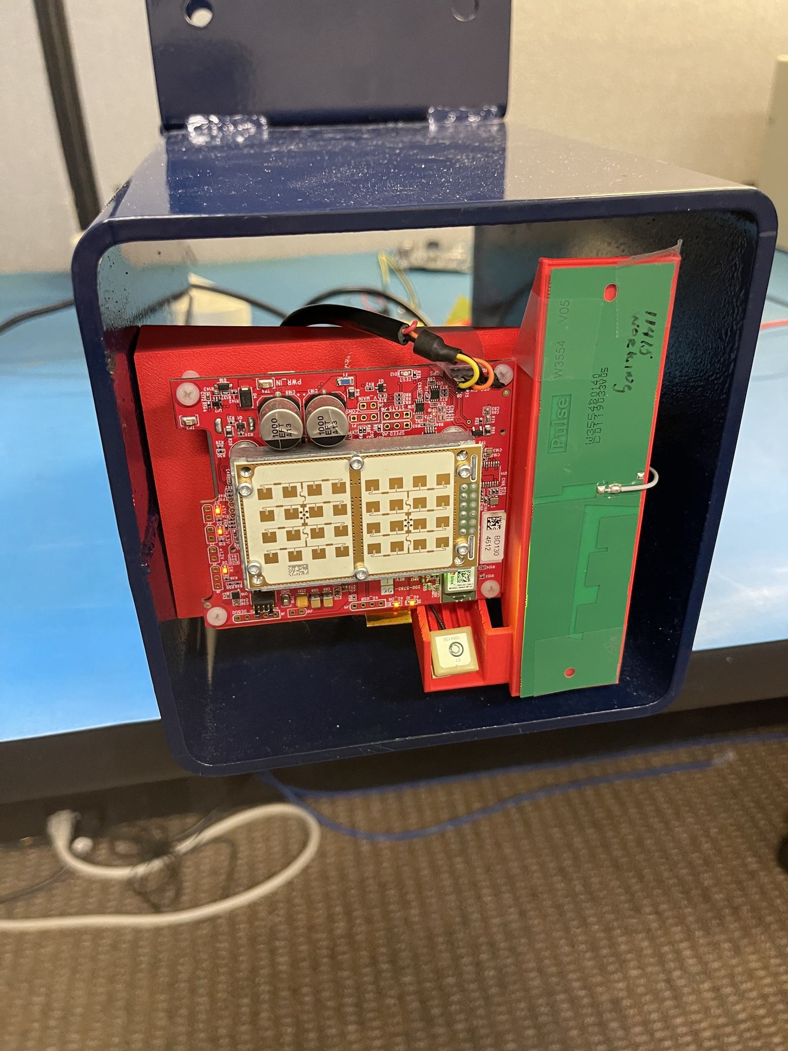 The radar unit opened up: the patch antenna array on its board, with the GPS and cellular antennas beside it.